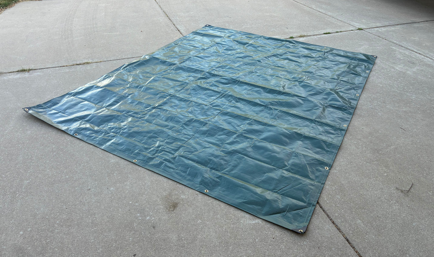 green tarp laying flat ready for yard bandit assembly
